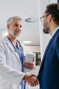 Pharmaceutical,Sales,Representative,Presenting,New,Medication,To,Doctor,In,Medical